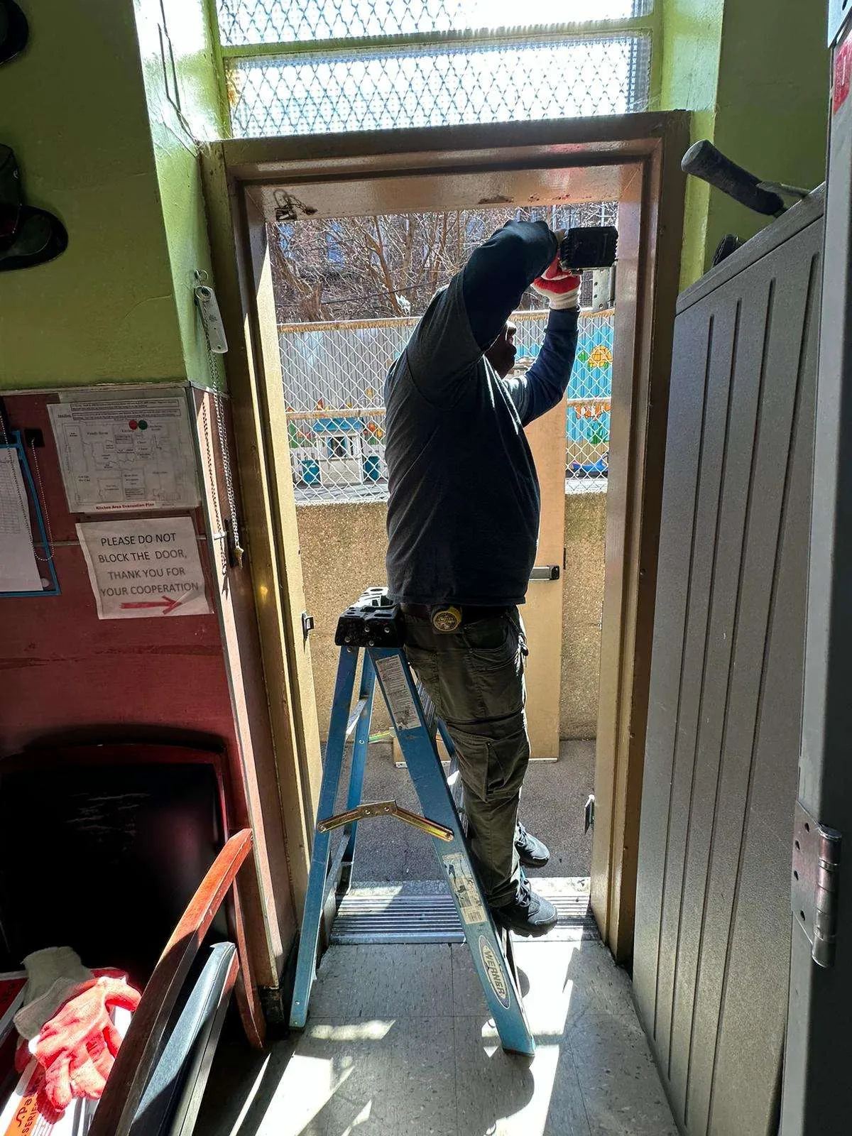Universal Fireproof Door technician inspecting fire-rated door assembly in NYC building