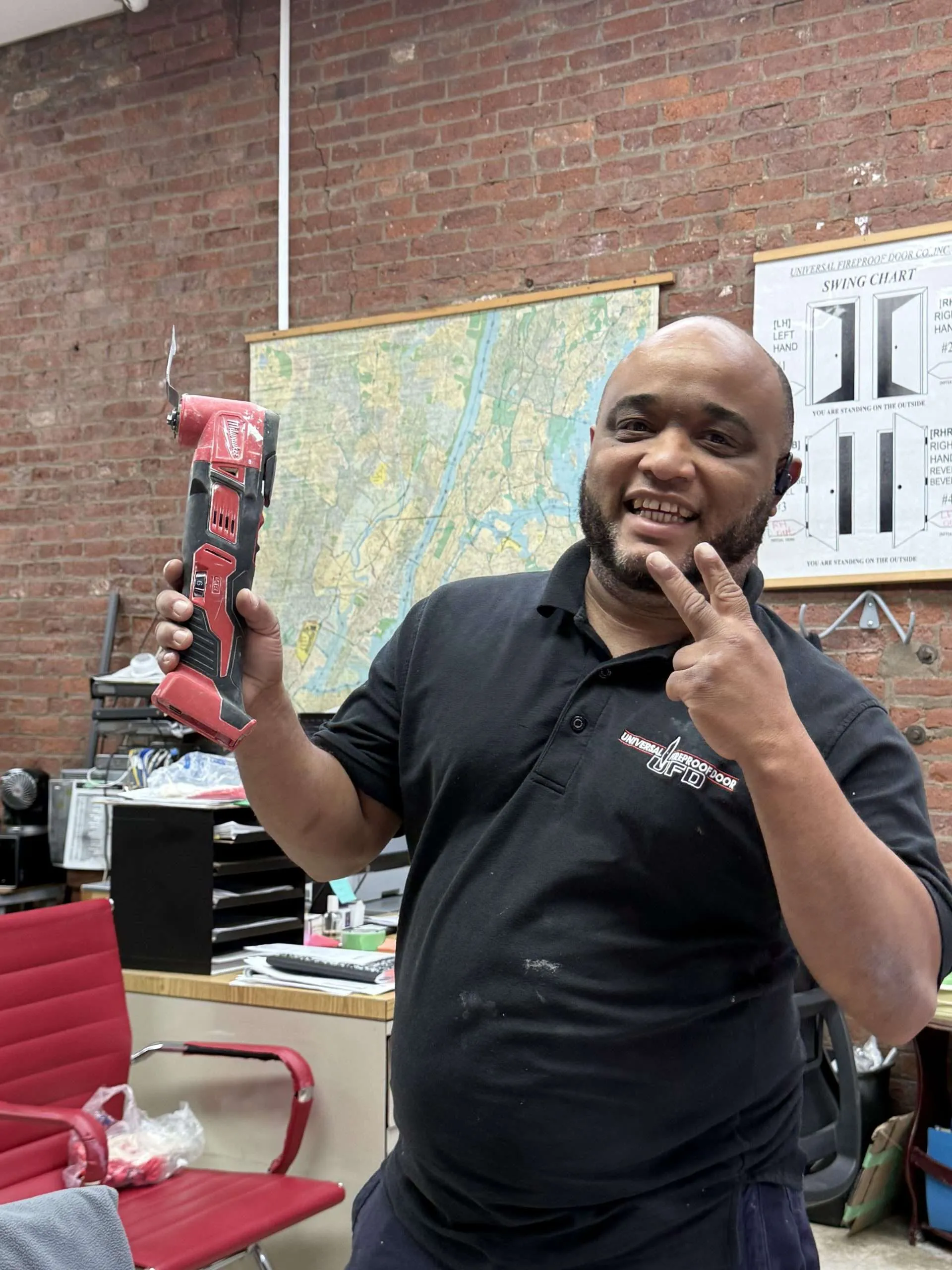 Fire door inspector checking NFPA 80 compliance on commercial steel door in NYC